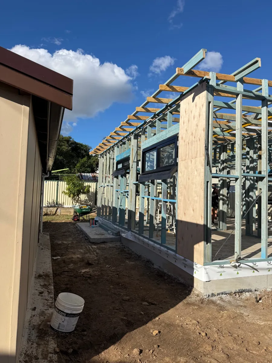 Granny flat wall frames, roof battens and plywood bracing beside an existing home in Sydney by Jirah Carpentry